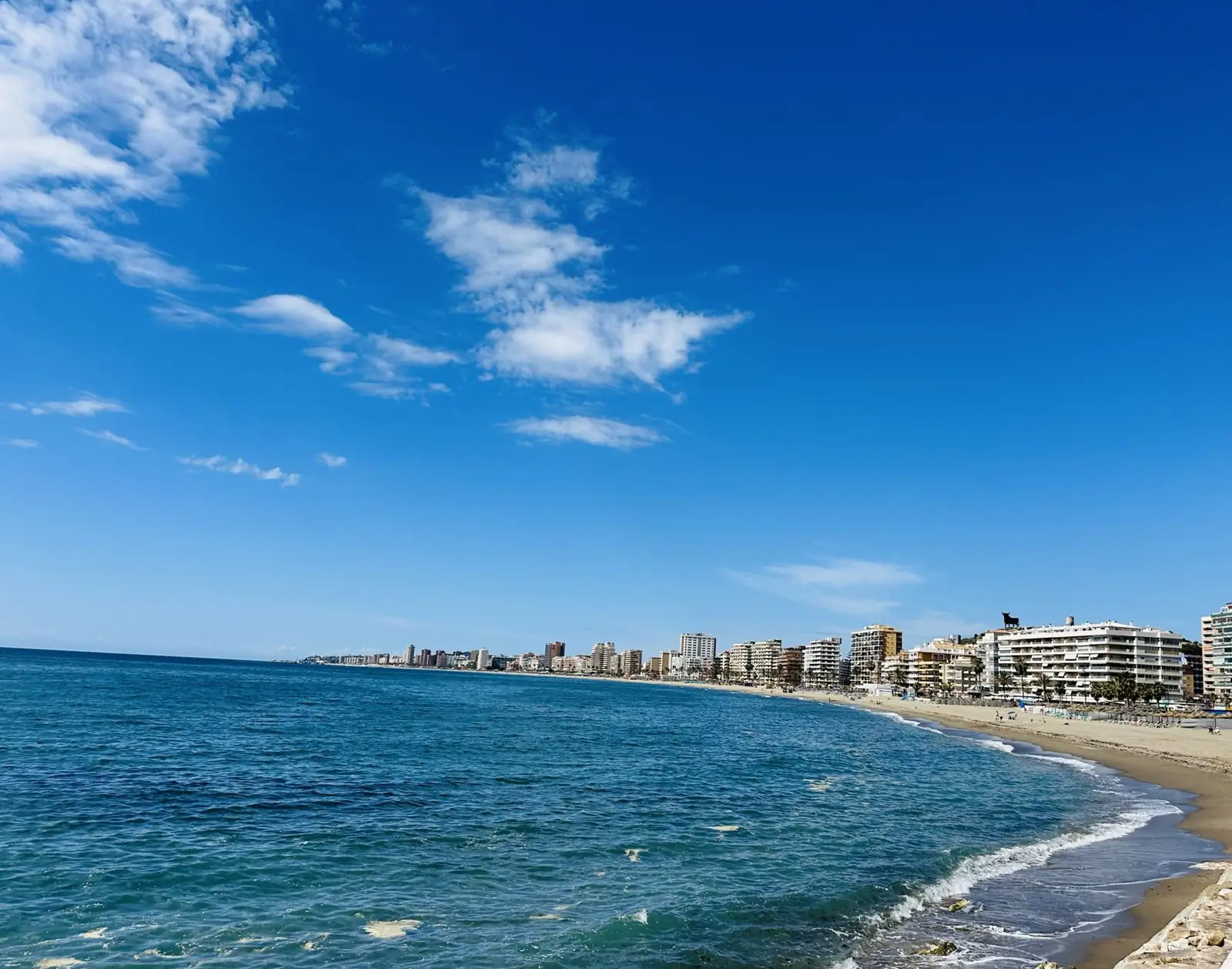 The curving beach and turquoise sea of the Costa del Sol near Malaga