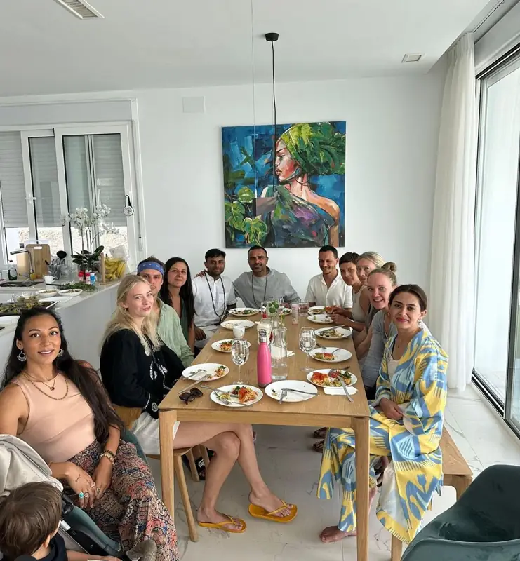 Retreat guests sharing a meal around a long table
