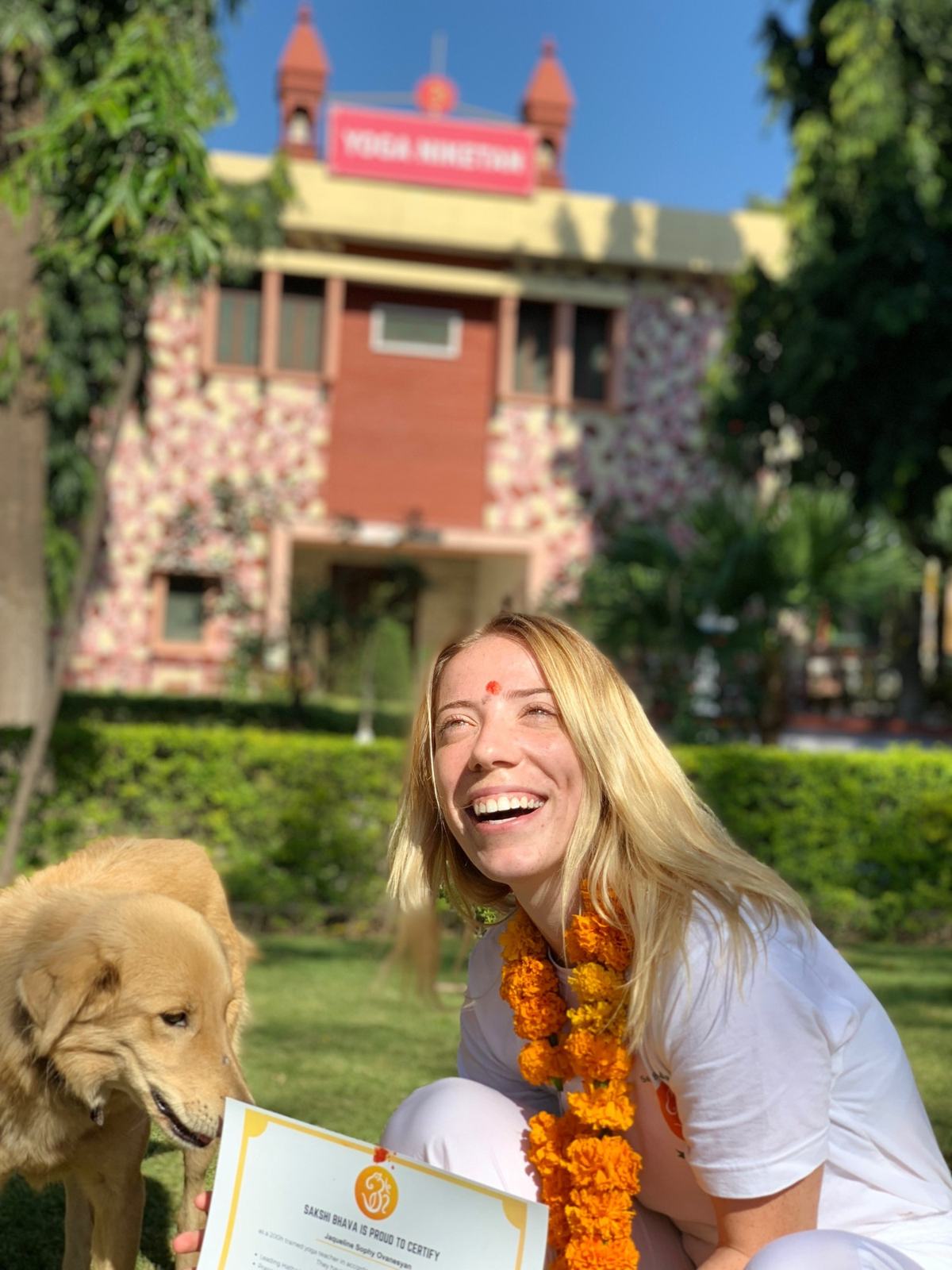 A graduate with her certificate outside the ashram