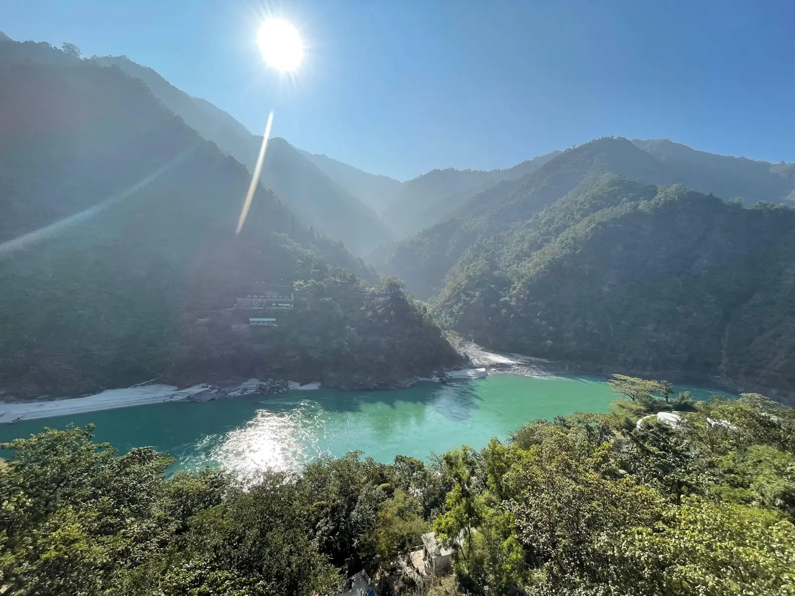 The turquoise Ganga winding between forested mountains above Rishikesh