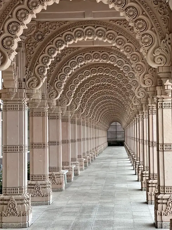 A corridor of carved stone arches