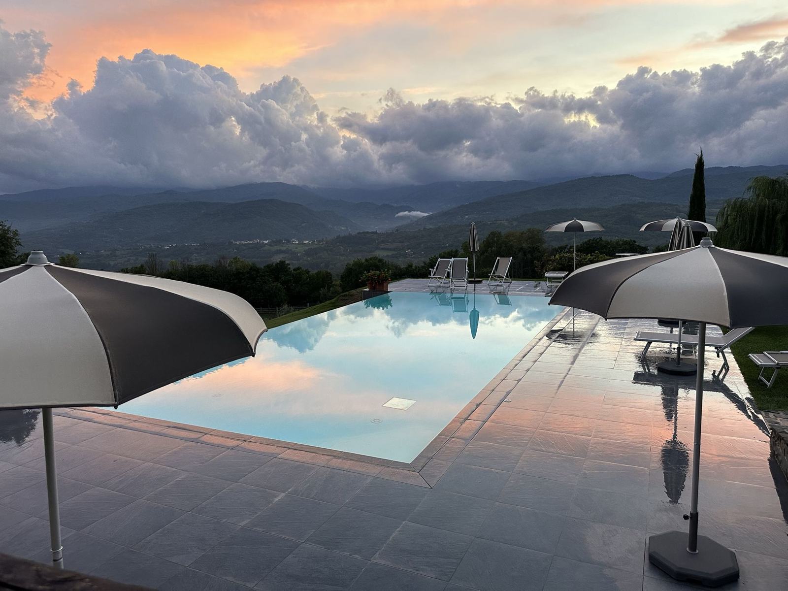 Sunset over a pool and the Tuscan hills from the training villa