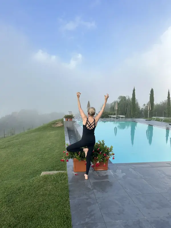 Tree pose beside the pool in the morning mist
